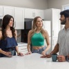 three people talking in the kitchen