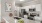 a kitchen with white cabinets and a bowl of fruit on a counter